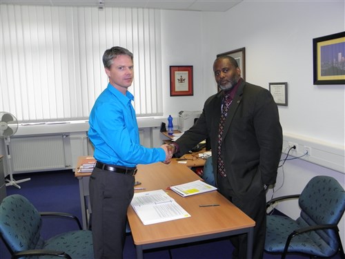 Brian Vaughan, a contracting specialist with 409th CSB, and Fred "Hank" Hankerson, U.S. Africa Command's Joint Training and Exercise Directorate Services, executive officer, shake hands at the end of a contracting strategy session in Stuttgart, Germany.