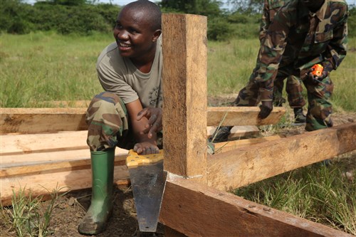 A Uganda People’s Defense Force soldier saws the top of a post in preparation to finish the flooring during a civil engineering exercise at Camp Singo, Nov. 16, 2015. The exercise helps the partner nations fortify their civil engineering skills while strengthening the bond between the two. (U.S. Marine Corps photo by Cpl. Olivia McDonald/Released)