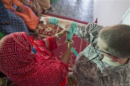 A student practices putting a splint on U.S. Army Sgt. 1st Class Ryan Watson, 407th Civil Affairs Battalion Functional (CA BN) Specialty Team NCO in charge, during a health class May 21, 2014, in Tadjoura, Djibouti. The 407th CA BN, which falls under the Combined Joint Task Force-Horn of Africa, hosted the four-day health classes for women of the Tadjoura and Ali Sabieh regions. (U.S. Air Force photo by Senior Airman Riley Johnson)