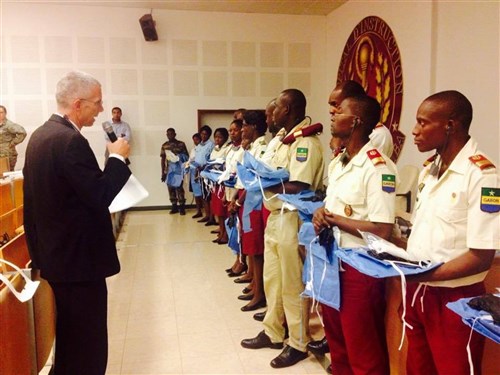 Infectious Disease Physician for the U. S. Defense Institute for Medical Operations (DIMO), Dr. Matthew Dolan, explains proper steps of donning personal protective equipment (PPE) to members of the Gabonese Military as part of a military-to-military engagement in Libreville, Gabon in October 2014.  DIMO, along with U.S. Africa Command and Gabonese Military Medical personnel and the country’s Ministry of Health (MOH) are in partnership for a mission to identify and develop the infection control activities framework that will strengthen Gabonese defense capabilities.  The partnership will also help to enhance the national and regional policies and security in the African country. (U.S. AFRICOM photo by Maj. Khadidja Harrell/Released).