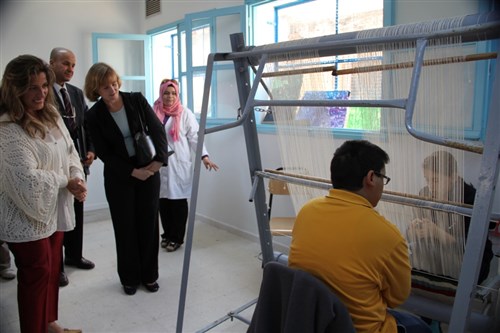 U.S. Deputy Chief of Mission Kathleen Hanson observes a weaving project at the special education vocational training center in Ariana, Tunisia Nov. 3. A $675,000 extension to the center was funded by the AFRICOM Humanitarian Assistance Program. 