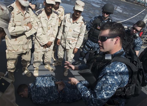 Electronics Technician 2nd Class Michael Downey, right, exchanges force protection and vessel-boarding knowledge with Mauritanian sailors aboard the Oliver Hazard Perry-class guided-missile frigate USS Elrod (FFG 55) during a scheduled port visit. Elrod is on a scheduled deployment supporting maritime security operations and theater security cooperation efforts in the U.S. 6th Fleet area of operation. (U.S. Navy photo by Mass Communication Specialist 2nd Class Tim D. Godbee/Released)