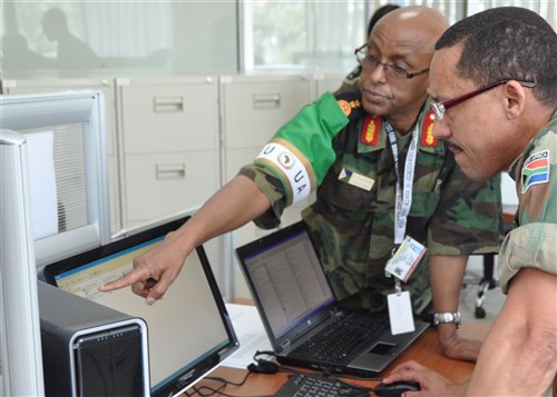 ADDIS ABABA, Ethiopia - Djiboutian Colonel Mustapha Handuleh, head of Operations and Plans, and Lieutenant Colonel Wally van Wyk, logistics support officer, collaborate on exercise scenarios during the Amani Africa command post exercise October 26, 2010 in Addis Ababa, Ethiopia. Aimed at determining and furthering the African Defense Force's operational capability, the 10-day exercise involves more than 120 African military components and police forces from North, East, West, South and Central African regions, along with and 75 civilians and various European Union partners. (AFRICOM photo by Staff Sergeant Amanda McCarty)