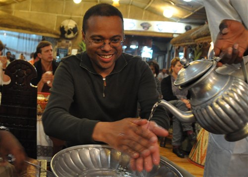 ADDIS ABABA, Ethiopia - Arthur Kelly, U.S. Africa Command C4 Systems, washes his hands after a meal at Yod Abyssinia, an Ethiopian restaurant in Addis Ababa. Kelly is currently working in Ethiopia to support the African Union and its African Standby Force command post exercise, named Amani Africa. (AFRICOM photo by Staff Sergeant Amanda McCarty)