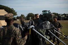 'Marines and sailors close a tent to be packed away during a command post exercise at Bogue Marine Corps Auxiliary Landing Field, N.Cc. Nov. 3, 2016.'