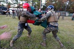 'Seaman Jacob Whittaker (right) battles out against an opposing squad member during the pugil stick portion of the 2nd Marine Logistics Group squad competition at Battle Skills Training School at Camp Lejeune, N.C., Nov. 17, 2016.  The pugil stick bout was one of over 20 events the eight squads participated in over the course of two days.  These events varied in physical and mental challenges, testing each squad’s ability to work as a team and to build camaraderie.  Whittaker is a corpsman with 2nd Medical Battalion.'