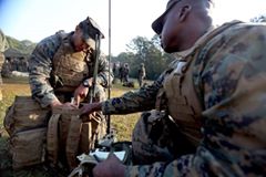 'Petty Officer Second Class Matthew Foreman (left) and Petty Officer Jerry Williams work together to successfully complete the radio load portion of the 2nd Marine Logistics Group squad competition at Battle Skills Training School at Camp Lejeune, N.C., Nov. 16, 2016.  The radio load was one of over 20 events the eight squads participated in over the course of two days.  These events varied in physical and mental challenges, testing each squad’s ability to work as a team and to build camaraderie.  Foreman and Williams are both corpsmen with 2nd Medical Battalion.'