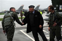 Deputy Commander, 32d Tactical Air Base, Lask, Poland, Lt Col Zbigniew Rosiak, greets pilots of the 176th Fighter Squadron, Madison, Wisconsin, upon arrival at Lask Air Base.