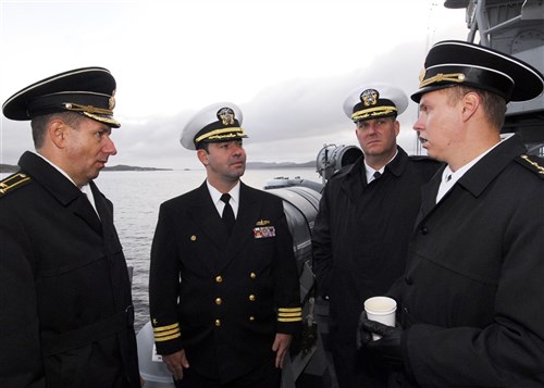 MURMANSK, Russia (Sep. 6, 2010) - Cmdr. Lyle Hall
(center), commanding officer of USS Taylor (FFG 50), visits with Capt. Konstantin Goulnev (far right) and Lt. Cmdr. Konstantin Sapozhnikov (left) of the International Military Cooperation Office, as the ship pulls in here. Taylor is in port to celebrate the close World War II alliance between Russia and the U.S., and to honor veterans in both countries on the 65th
anniversary of the end of World War II. (U.S. Navy photo by Mass Communication Specialist 1st Class Edward Kessler/Released)