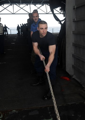 MEDITERRANEAN SEA (March 17, 2011) -- Hospital Corpsman 3rd Class Joel Babino helps haul in a line during a replenishment at sea between the fleet replenishment oiler USNS Lewis and Clark (T-AKE 1) and amphibious assault ship USS Kearsarge (LHD 3).  Kearsarge is the command ship of Kearsarge Amphibious Ready Group, supporting maritime security operations and theater security cooperation efforts in the U.S. 6th Fleet area of responsibility. (U.S. Navy Photo By Mass Communication Specialist 2nd Class (SW) Stevie Tate/Released) 