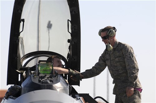 AVIANO AIR BASE, Italy (March 20, 2011) - A 31st Fighter Wing F-16 Fighting Falcon pilot receives a handshake from a member of his flight crew at Aviano Air Base after returning from supporting Joint Task Force Odyssey Dawn (JTF OD). JTF OD is the U.S. Africa Command task force established to provide operational and tactical command and control of U.S. military forces supporting the international response to the unrest in Libya and enforcement of United Nations Security Council Resolution (UNSCR) 1973.  UNSCR 1973 authorizes   "all necessary measures" to protect civilians in Libya under threat of attack by Qadhafi regime forces.  JTF Odyssey Dawn is commanded by U.S. Navy Admiral Samuel J. Locklear, III.  (US Army Photo by SSG Tierney P. Wilson/Released)