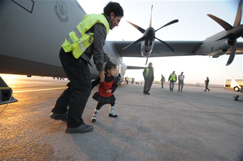 CAIRO, EGYPT (March 15, 2011) - An Egyptian girl emerges from an Air Force C-130J after a flight from Djerba Zarzis Airport in Tunisia. These Egyptian citizens are among tens of thousands who have fled conflict in Libya to Tunisia, where a humanitarian crisis is unfolding. This C-130J, flown by the 37th Airlift Squadron from Ramstein Air Base, Germany, is part of a contingent of aircraft from the 37th AS and the 26th U.S. Marine Expeditionary Unit that are transporting the evacuees home. The airlift is part of a broader U.S. government effort led by the Department of State to assist with the crisis. (U.S. Army photo by Staff Sgt. Brendan Stephens/Released)