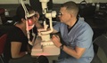 Army Maj. Brad Cunningham provides a slit lamp examination during a free optometry clinic at Juarez-Lincoln High School in Mission, Texas, during a weeklong humanitarian mission to provide vision services to people living in the Rio Grande Valley. (Courtesy photo)