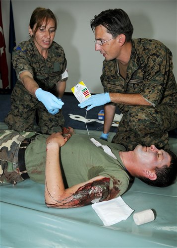 A team of medical professionals treat a simulated casualty for injuries during a mass casualty exercise to conclude the Critical Life Saving Skills for First Responders course here June 1, 2012. During the course, instructors from the Defense Institute for Medical Operations worked with other countries' medical practitioners attending Shared Resilience 2012 to exchange medical ideas and techniques. More than 500 military members from nine nations are participating in the annual U.S. Joint Chiefs of Staff sponsored exercise May 28 - June 8. The goals of the exercise are to strengthen interoperability, facilitate training in crisis response and disaster management, and validate the readiness of deployable military medical and humanitarian assistance teams. The exercise, in the spirit of partnership for peace, directly supports U.S. European Command's theater cooperation efforts and strategy for active security with European countries.