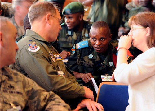 KINSHASA, Democratic Republic of the Congo - U.S. Air Force and Democratic Republic of the Congo personnel speak before the opening ceremonies for the MEDLITE 11 exercise, April 25, 2011. MEDLITE 11 is a joint medical exercise focused on aeromedical evacuation, to improve the readiness of U.S. Air Force and DRC personnel. (U.S. Air Force photo by Technical Sergeant Todd Wivell)