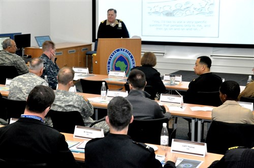 CDR Richard Gustafson, Office of the Undersecretary of Defense for Policy, briefs on DoD Global Health Engagement during the 2015 AFRICOM Partners Health Engagement Forum, a three-day event conducted at the U.S. Army Garrison Stuttgart, Germany at Kelley Barracks, Feb. 18-20, 2015.  The event was organized by the AFRICOM Command Surgeon’s Office.  (U.S. Africa Command photo by Tech. Sgt. Olufemi A. Owolabi)