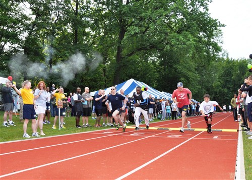 STUTTGART, Germany - Participants of U.S. Africa Command's 2nd annual Olympics take part in the 400 meter relay, August 10, 2012. The Olympics provided a day for AFRICOM to build camaraderie, esprit de corps, and professional and personal relationships between team members and their families while enjoying games, food, and social activities. Events included track, flag football, basketball, kickball, dodgeball, water balloon toss, and a chili cook-off, among many others. The overall winners of the AFRICOM Olympics were the J3 (Operations and Cyber) and J4 (Logistics) directorates.  (U.S. AFRICOM photo by Danielle Skinner)