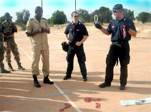 Italian Carabinieri, Warrant Officer 5 Marco Rigoni and Warrant 
Officer 3 Andrea Guida instruct Burkina Faso Gendarmerie on United Nations 
standards for using law enforcement restraining devices. Rigoni and Guida 
represent the Center of Excellence for Stability Police Units known as CoESPU 
and augmented U.S. Army Africa- coordinated instructors during a recent 
three-week law enforcement training event in Burkina Faso. (U.S. Army Africa 
photo)
