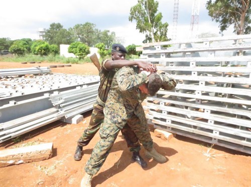 A service member with the Togolese Armed Forces conducts a personnel search on 1st Lt. Kyle Faherty during a armed sentry training engagement with U.S. Marines in Lome, Togo, Dec. 4, 2014. In Togo, the Marines trained alongside 20 students from the Togoloese Army, Air Force, Navy and the Gendarmerie forces. Training in both regions focused on weapons safety and handling, rules of engagement, escalation of force, personnel and vehicle searches, vehicle entry points as well as entry control points—ending with a final exercise that tested the collective tactical knowledge learned over the course of the training engagement. Marines with SPMAGTF Crisis Response-Africa conducted the theater security cooperation engagement to help develop and enhance armed sentry skills sharing tactics, techniques and procedures with the Togolese Armed Forces. (Courtesy Photo)