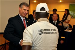 Michael Hryshchyshyn, chief of U.S. Africa Command’s Humanitarian and Health Activities, congratulates one of the participants of the tabletop exercise to test Nigeria’s Disaster and Pandemic Response Plans during the closing ceremony in Abuja, Nigeria, November 22, 2013.  More than 100 disaster response experts from Nigeria, as well as observing countries including Burkina Faso, Ghana, Kenya, Senegal, and Uganda, participated in the tabletop exercise. The exercise was funded by U.S. Africa Command in collaboration with the U.S. Center for Disaster and Humanitarian Assistance Medicine (CDHAM).  (U.S. AFRICOM photo by Technical Sergeant Olufemi A. Owolabi/Released)