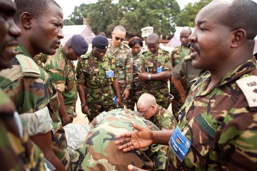 BANJUL, The Gambia - Kenyan Lieutenant Colonel Stanley Wairegi discusses operations of the radio antenna unit used to establish communications between Africa Endeavor's main site in The Gambia and a satellite site at the Economic Community of West African States headquarters in Nigeria with other delegates at Fajara Barracks, Banjul, The Gambia, July 13, 2011.  Africa Endeavor 2011 encompasses three different sites--the main site in The Gambia, the ECOWAS headquarters in Nigeria and the African Union headquarters in Addis Ababa, Ethiopia. (AE photo by Sergeant Daniel T. West)