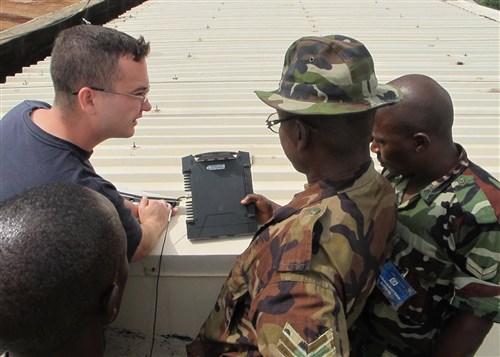 ABUJA, NIGERIA - Lance Corporal Adeoye Omidiji, Corporal Mohammed Chindo, and Sergeant Benibo Onimite, Nigerian soldiers from the Economic Community of West African States (ECOWAS) Combat Forces Signal Squadron, practice setting up and operating a Broadband Global Area Network satellite system, as they receive guidance from Sergeant Ryan Kish, U.S. Marine Forces Africa, June 12, 2011. The training was part of exercise Africa Endeavor, a U.S. Africa Command-sponsored initiative focusing on interoperability and information sharing. AE 2011 takes place simultaneously in Banjul, The Gambia, Abuja, Nigeria, and Addis Abba, Ethiopia. (U.S. AFRICOM photo by Lieutenant Colonel Steven Lamb)