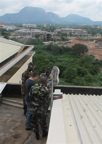 ABUJA, NIGERIA - Lance Corporal Adeoye Omidiji, Corporal Mohammed Chindo, and Sergeant Benibo Onimite, Nigerian soldiers from the Economic Community of West African States (ECOWAS) Combat Forces Signal Squadron, practice setting up and operating a Broadband Global Area Network satellite system, as they receive guidance from Sergeant Ryan Kish, U.S. Marine Forces Africa, June 12, 2011. The training was part of exercise Africa Endeavor, a U.S. Africa Command-sponsored initiative focusing on interoperability and information sharing. AE 2011 takes place simultaneously in Banjul, The Gambia, Abuja, Nigeria, and Addis Abba, Ethiopia. (U.S. AFRICOM photo by Lieutenant Colonel Steven Lamb)