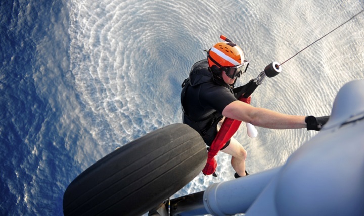 A search and rescue corpsman prepares to deploy from a MH-60S Seahawk helicopter during search and rescue swimmer training. 