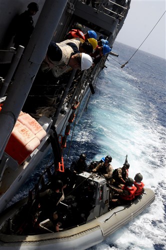 ATLANTIC OCEAN - U.S. Coast Guardsmen, sailors and members of Cape Verde's boarding team return to the guided-missile frigate USS Simpson (FFG 56) after conducting boarding procedures on a fishing vessel, April 17, 2012. USS Simpson is supporting African Maritime Law Enforcement Partnership (AMLEP) operations, a branch of Africa Partnership Station (APS), in an effort to build maritime safety and security on and off shore. During the deployment, Simpson will work with host nation law enforcement teams to deter illicit maritime activities. (U.S. Navy photo by Mass Communication Specialist Seaman Brian T. Glunt) 