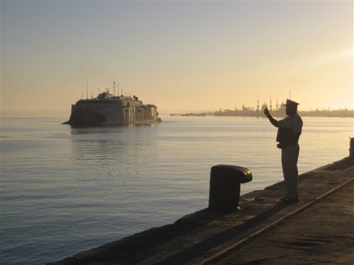 WALVIS BAY, Namibia - Commander Gotlieb Pandeni of the Namibian Navy takes a photograph as High-Speed Vessel Swift (HSV 2) pulls into Walvis Bay, May 22, 2012. This is the U.S. Navy's first-ever Namibian port visit in support of Africa Partnership Station (APS) 12.  APS is an international security cooperation initiative aimed at strengthening global maritime partnerships through training and collaborative activities to improve maritime safety and security in Africa. (U.S. Navy photo by Lieutenant Commander Suzanna Brugler)