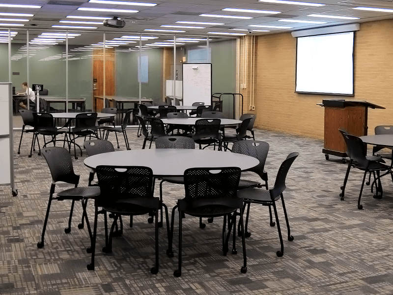 study room with tables, chairs, TV screen