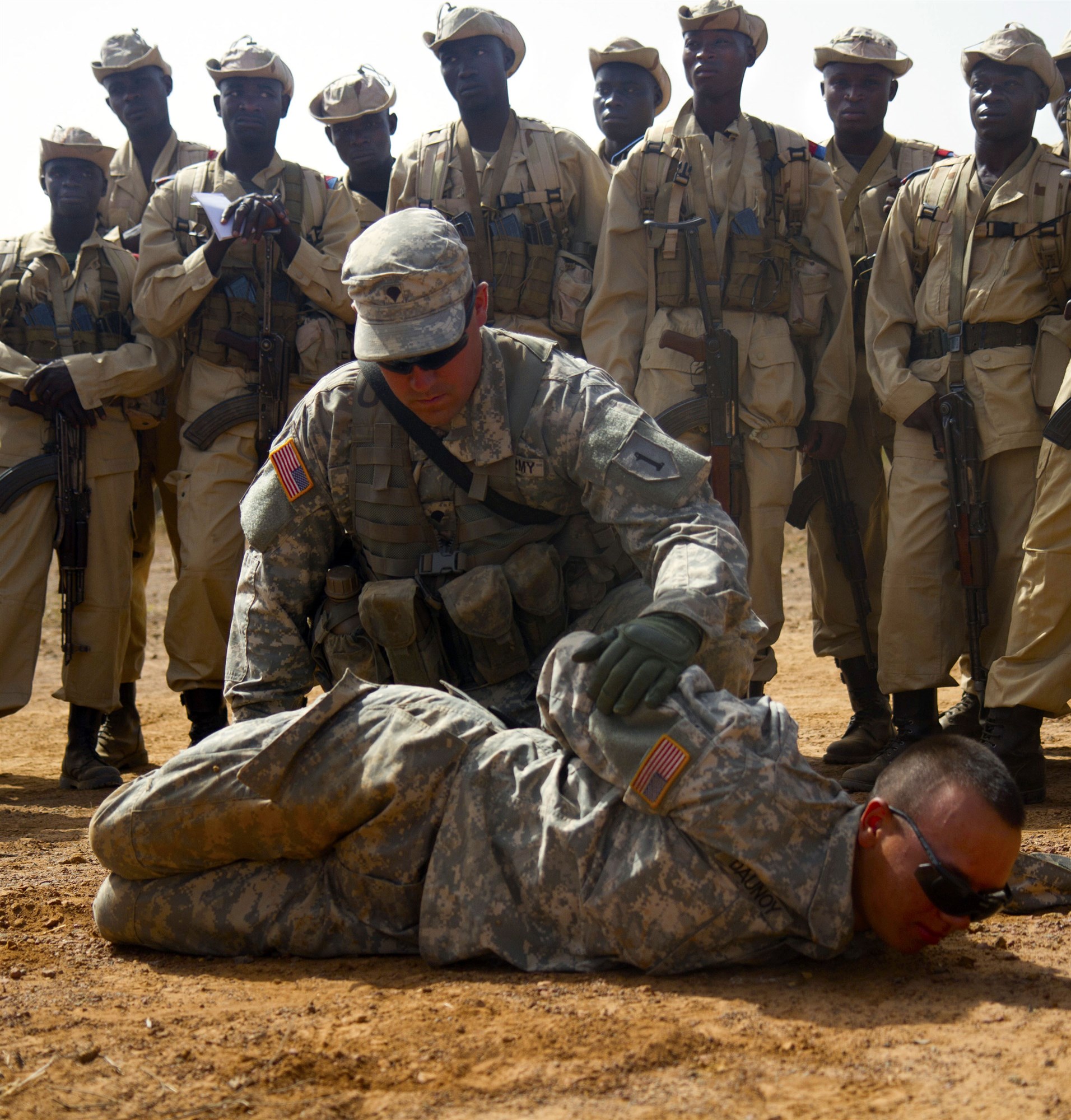 Pvt. Brett A. Dounoy and Spc. Mathew D. Minchin, both infantryman with Alpha Co., 1st Bn., 28th Inf. Regt., 4th IBCT, 1st Inf. Div., demonstrate search and seize techniques during a class given to the Burkina Faso Army soldiers at Camp Thies, Senegal, June 17. This training is part of Exercise Western Accord 14, which is dedicated to building a strong partnership with Economic Community of West African States and other partner nations. (U.S. Army Africa photo by Sgt. Takita Lawery)