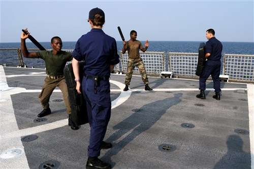 U.S. COAST GUARD CUTTER DALLAS, At sea - Sao Tome Coast Guard members, Ensign Jimmy Tiny (front) and Second Lieutenant Ramoon Nascimento (rear), practice maritime-law enforcement tactics with Ensign Katie Smith and Petty Officer 1st Class Eduardo Vitorino aboard the Coast Guard Cutter Dallas June 30, 2008. During the five-day training event, U.S. and Sao Tome and Principe coast guard members joined together to practice a variety of maritime security techniques, including law enforcement tactics, small boat operations, and visit, board, search, and seizure procedures.  Dallas is deployed to West Africa in support of Commander, U.S. Naval Forces Europe, Sixth Fleet's Africa Partnership initiative. (Photo by Petty Officer First Class Tasha Tully, Africa Partnership Station)