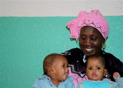 DAKAR, Senegal - A volunteer plays with two children at the Vivre Ensemble orphanage in Dakar, Senegal, after a team of APS Nashville members delivered donated school supplies from Project Handclasp, January 9, 2009. The Norfolk-based amphibious transport dock ship, USS Nashville (LPD 13), is deployed as a part of Africa Partnership Station, an international initiative developed by U.S. Naval Forces Europe and Naval Forces Africa, which aims to work cooperatively with U.S. and international partners to improve maritime safety and security in Africa. (U.S. Navy photo by Lieutenant Doug High)