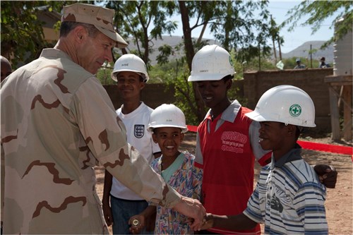 DIRE DAWA, Ethiopia (May 22, 2012) - U.S. Navy Rear Admiral Michael Franken, Combined Joint Task Force - Horn of Africa commander, presents command coins to local students for helping U.S. Navy Naval Mobile Construction Battalion Three Seabees during the construction of their new school building and latrines at the Gende Gerada Primary School here May 22. The students from left to right are Abdurehim Nasir, Amir Abdi, Ramzii Ahamed and Anwar Tayir. Seabees from CJTF-HOA were the last of four NMCB teams to work on the two year project, which was dedicated at a ceremony here May 22. (U.S. Air Force photo by Tech. Sgt. Ryan Labadens)