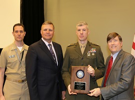 (April 20, 2016) Maj. Nicholas Webb, center right, officer in charge of the MCEN Operations Branch, receives the Department of the Navy Cyberspace IT Person of the Year Award from Department of the Navy Chief Information Officer Robert Foster, right, Ron Zich, executive assistant to the director of C4, Cmdr. Damen Hofheinz during the Navy Information Management and Information Technology Excellence Awards ceremony at the Washington Convention Center in Washington, D.C. (U.S. Navy photo by Mass Communication Specialist 3rd Class Brenton Poyser/Released)  