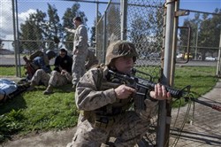 Sergeant Brian Hutchinson, Special-Purpose Marine Air-Ground Task Force Africa 13 motor transportation chief, provides security during the final exam of the Tactical Combat Casualty Care course here, March 14, 2013. The TCCC course teaches basic first-responder skills and helps service members prioritize casualty care in combat situations to maximize safety and effective care. Special-Purpose MAGTF Africa strengthens US Marine Corps Forces Africa and US Africa Command's ability to assist partner nations in addressing their security challenges. The approximately 150 Marines and sailors conduct security force assistance, military-to-military engagements and are trained to provide support to crisis response. (Photo by Corporal Timothy Norris)