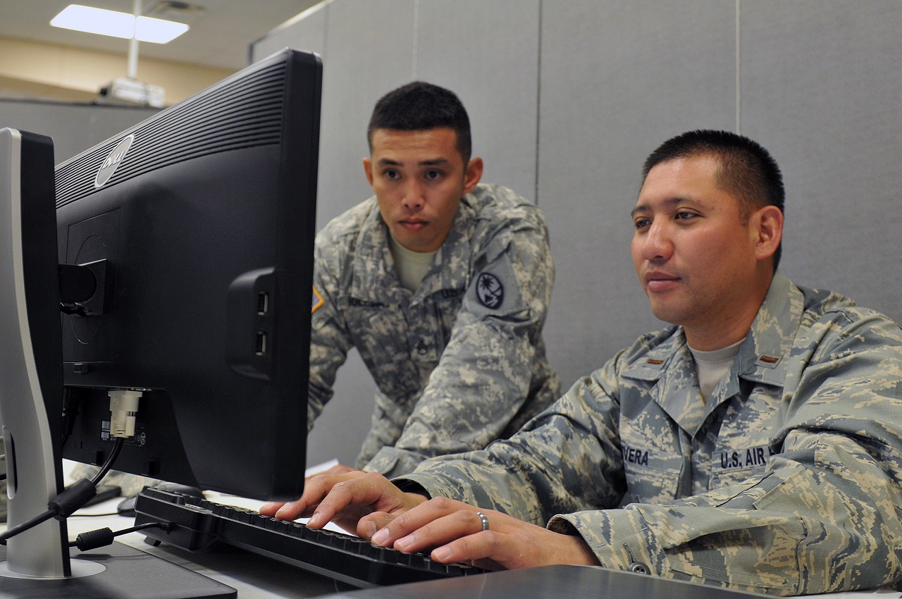 Staff Sgt. Vincent Iglesias of the 1st Battalion, 294th Infantry, Guam Army National Guard (left), and 2nd Lt. Tommy Rivera of the 254th Air Base Group, Guam Air National Guard, verify accounts of their fellow Blue Team 6 members during exercise Cyber Shield 2016 at Camp Atterbury, Ind., April 22, 2016. The 'mini-exercise' helped team members identify issues and ensure systems were up and running prior to the main exercise. Photo Credit: Sgt. Stephanie A. Hargett 