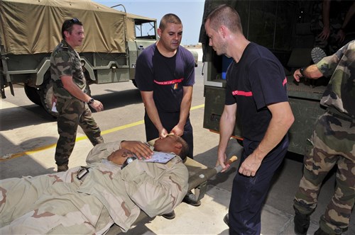 FRENCH FORCES DJIBOUTI, Djibouti (Sept. 25, 2012) - A U.S. Navy Sailor is loaded onto a field ambulance by French medical personnel at the simulated triage site on French Forces Djibouti base, Djibouti, Sept. 25, 2012, during a mass casualty exercise that involved French and U.S. military forces. The exercise followed a fictitious storyline, but called for the employment of real-world assets. While French and U.S. forces conduct frequent combined training events, this was the first exercise of this type between the two nations in Djibouti. The U.S. forces involved are assigned to Combined Joint Task Force - Horn of Africa, or CJTF-HOA. CJTF-HOA works with coalition partners, such as the French, and with countries in East Africa to promote regional security and stability. (U.S. Air Force photo by Technical Sergeant Donald R. Allen)