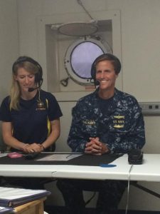 Rear Adm. Tim Gallaudet, Oceanographer of the Navy and Commander, Naval Meteorology and Oceanography Command, with Ocean Exploration Trust Community STEM Program coordinator Megan Cook prepares to “go live” during a transmission from E/V Nautilus to a stateside science education center. The Nautilus expedition conducted the first visual survey of USS Independence since the ship was scuttled in 1951. U.S. Navy photo by Lt. Tara Elliott 