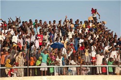 DJIBOUTI, Djibouti (March 2, 2012) - Spectators cheer as runners cross the finish line at Gouled National Stadium here during the 16th Annual Djibouti International Semi-Marathon March 2. More than 40 U.S. service members and civilians from Camp Lemonnier, Djibouti, ran alongside 800 other international runners during the event. (U.S. Air Force photo by Technical Sergeant Ryan Labadens)