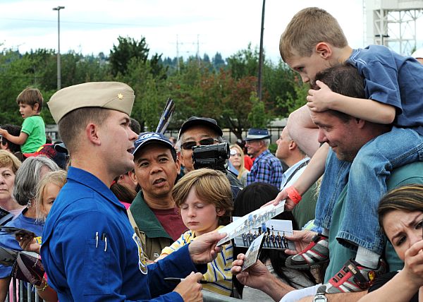 SEATTLE (Aug. 8, 2010) Lt. Cmdr. Frank Weisser, the lead solo pilot of the U.S. Navy flight demonstration team, the Blue Angels, signs autographs during the 61st annual Seattle Seafair Navy Week. Seafair activities allow U.S. and Canadian Sailors and Coast Guard personnel to experience the local community and to promote awareness of the maritime forces. U.S. Navy photo by Mass Communication Specialist 1st Class Thomas J. Brennan.