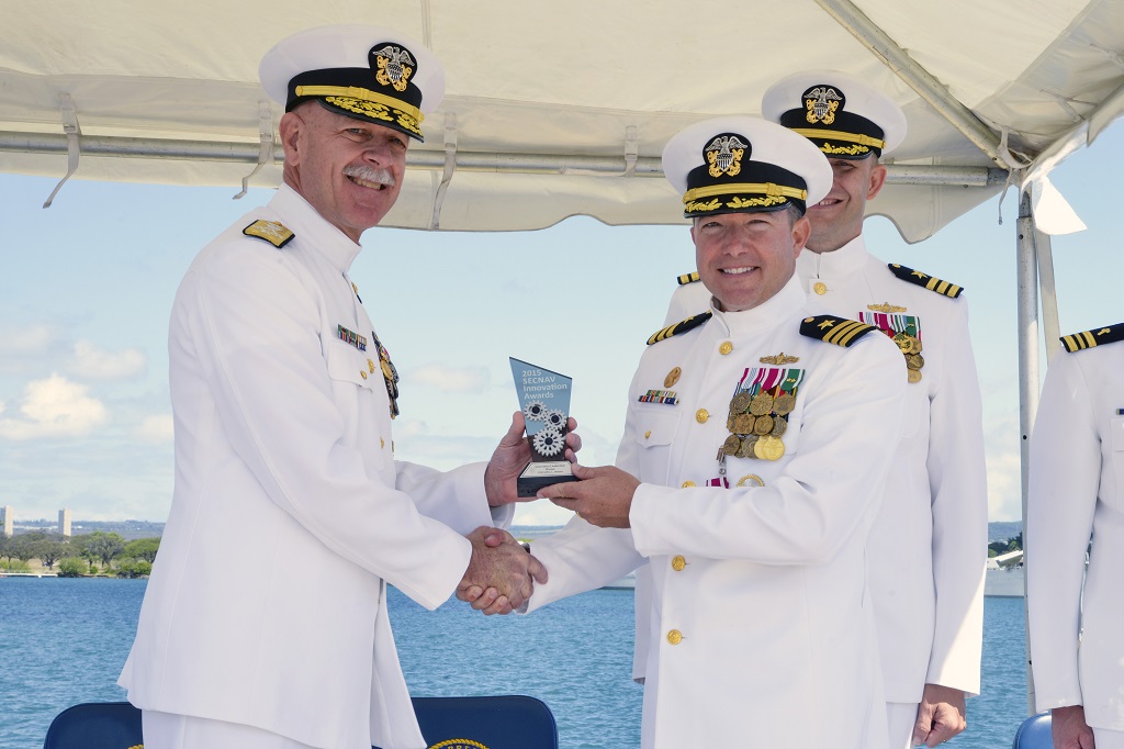 PEARL HARBOR (April 22, 2016) Adm. Scott Swift, commander of U.S. Pacific Fleet, presents Cmdr. Jeffery Heames, commanding officer of the Arleigh Burke-class guided-missile destroyer USS Preble (DDG 88), the 2015 SECNAV Innovation Award for the innovation leadership category during Heames' change of command ceremony at Joint Base Pearl Harbor Hickam. The SECNAV Innovation Awards Program seeks to recognize top talented Sailors, Marines and civilians or teams who made significant innovative achievements during the calendar year 2015. U.S. Navy photo by Mass Communication Specialist 2nd Class Tamara Vaughn