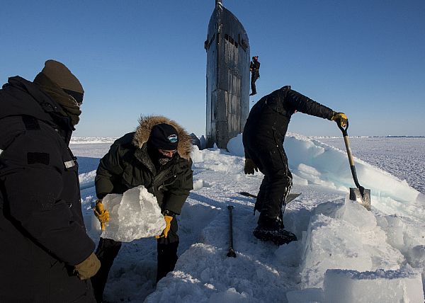 ARCTIC CIRCLE (March 14, 2016) Sailors and civilians, assigned to Arctic Submarine Lab, clear the ice from the hatch of USS Hampton (SSN 767) during Ice Exercise (ICEX) 2016. ICEX 2016 is a five-week exercise designed to research, test, and evaluate operational capabilities in the region. ICEX 2016 allows the U.S. Navy to assess operational readiness in the Arctic, increase experience in the region, advance understanding of the Arctic environment, and develop partnerships and collaborative efforts. U.S. Navy photo by Mass Communication Specialist 2nd Class Tyler Thompson.