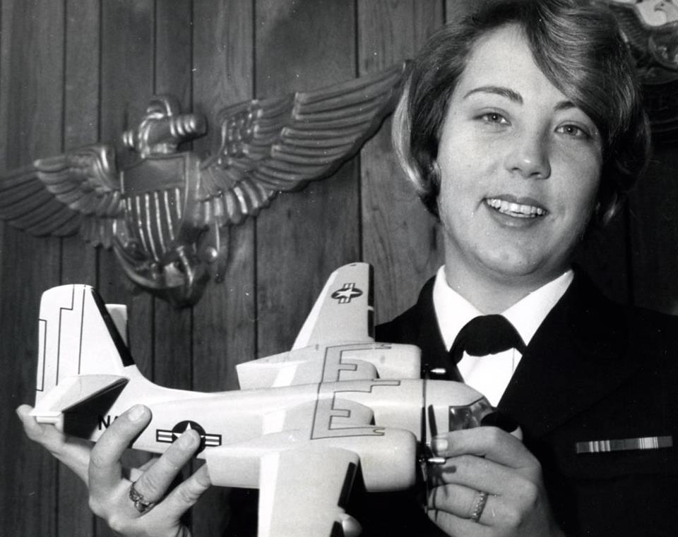 Ensign Kathleen McNary holds a model of the TS-2 Tracker aircraft, which she hopes to learn to fly at Naval Air Station Corpus Christi, Texas. Photographed by PH1 Jim Haynes. NHHC Photograph Collection, L-File, Women Topics – Aviation.