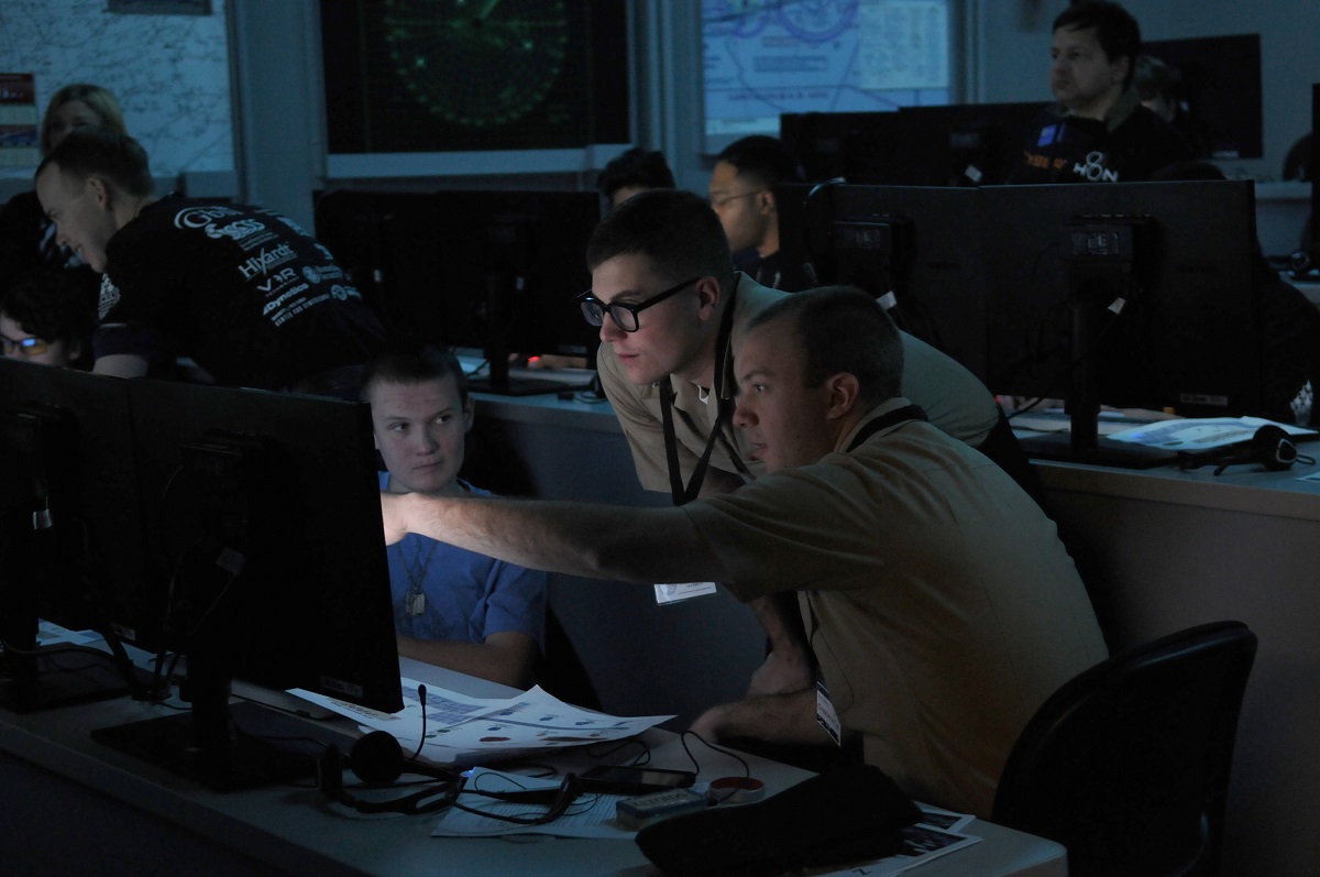 PENSACOLA, Fla. (Jan. 23, 2016) Information warfare Sailors from the Center for Information Dominance Unit Corry Station mentor a high school student during CyberThon, an event designed to develop the future cybersecurity workforce.  Hosted by the Blue Angels Chapter of the Armed Forces Communications and Electronics Association, CyberThon challenged the students to play the role of newly hired information technology professionals tasked with defending their company's network. U.S. Navy photo by Carla M. McCarthy 
