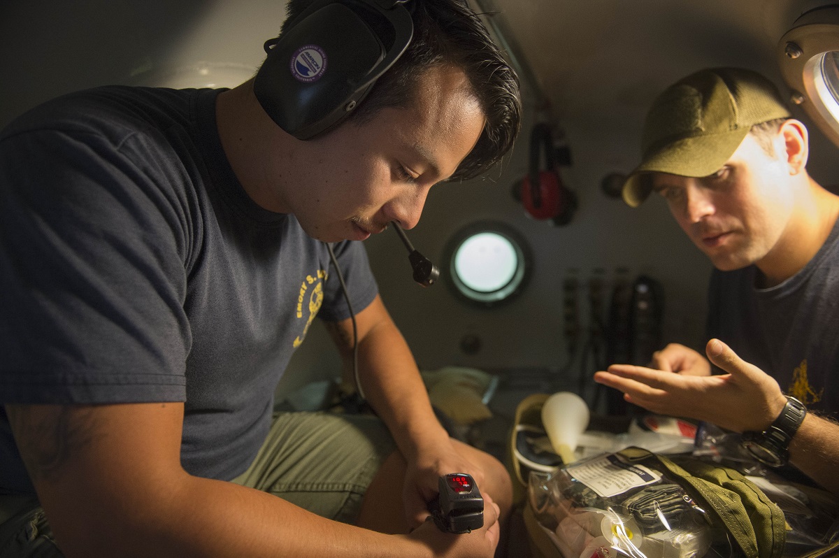 BAHRAIN (Dec. 22, 2105) Navy Diver 2nd Class Jonathan Miranda (left) and Hospital Corpsman 2nd Class Ryan McGovern, assigned to Commander, Task Group (CTG) 56.1, test medical equipment inside of a Standard Navy Double Lock Recompression Chamber System. CTG 56.1 conducts mine countermeasures, explosive ordnance disposal, salvage-diving, and force protection operations throughout the U.S. 5th Fleet area of operations.  U.S. Navy Combat Camera photo by Mass Communication Specialist 2nd Class Shannon Burns 