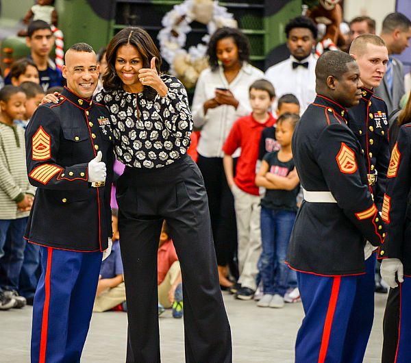 WASHINGTON (Dec. 9, 2015) First lady Michelle Obama poses for a photo with a Marine after the Marine Corps Foundation's Toys for Tots drive annual sorting event at Joint Base Anacostia-Bolling. U.S. Navy photo by Scott Pauley.