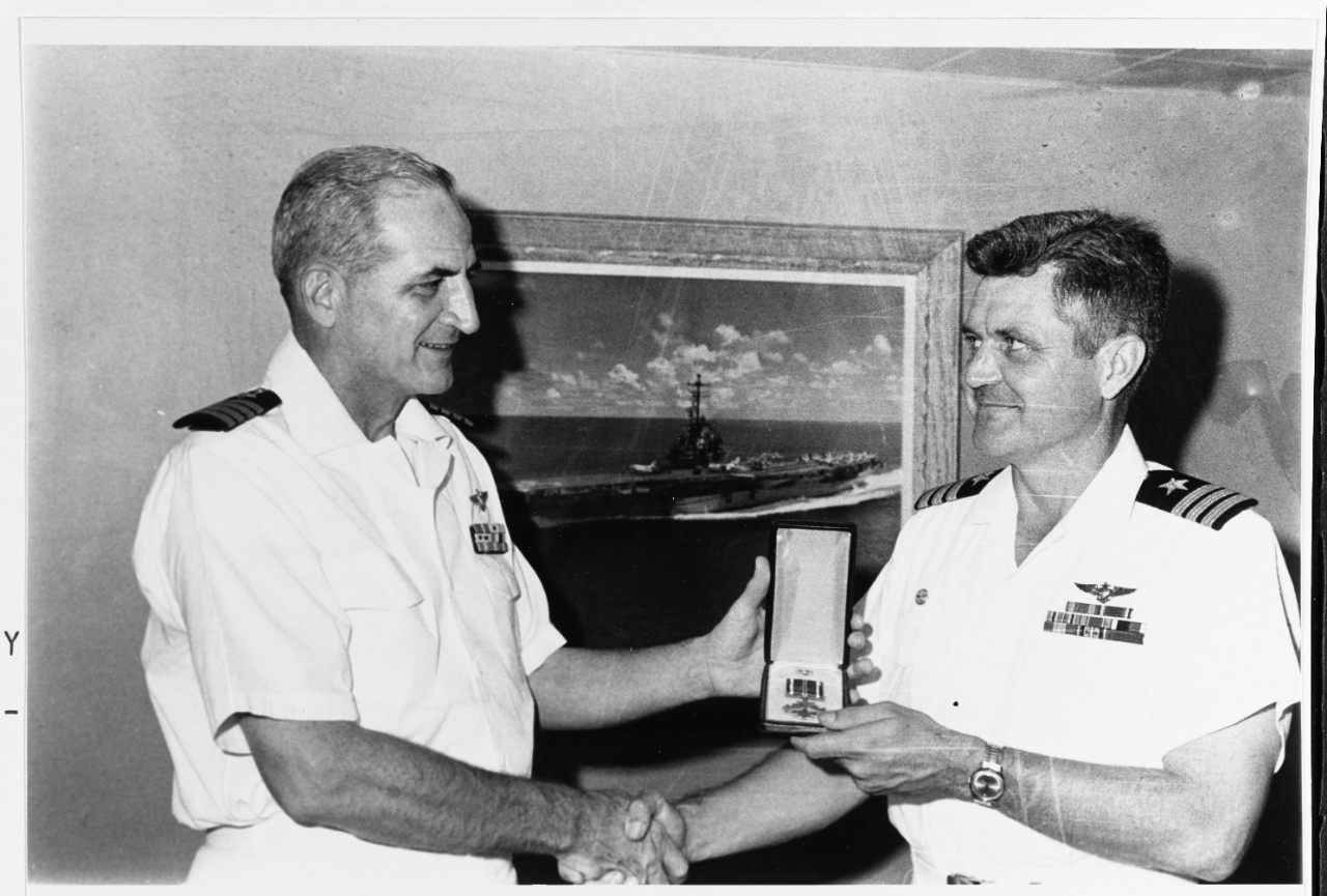 Cmdr. James B. Stockdale, ComAirWing16 is presented with the Distinguished Flying Cross by Capt. Bartholomew J. Connolly III, commanding officer of USS Oriskany (CVA 34) during her 1965 WestPac deployment, Aug 13, 1965. The award was presumably received for actions taken early in the Vietnam War. National Archives photo