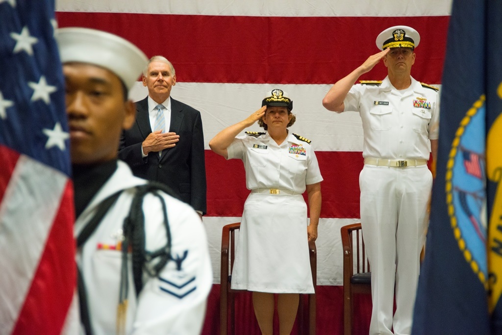 Capt. Danelle Barrett (center), Chief of Staff, Navy Information Dominance Forces (NAVIDFOR) salutes during presentation of colors before being promoted to Rear Admiral (Lower Half). Rear Adm. Matthew J. Kohler (right), Commander, NAVIDFOR provided the opening remarks then presented Barrett with the Legion of Merit (gold Star In lieu of second award). Retired Adm. William J. Fallon (left) was guest speaker for the ceremony and recited the oath of office to Admiral Barrett. U.S. Navy photo by Michael Morris.